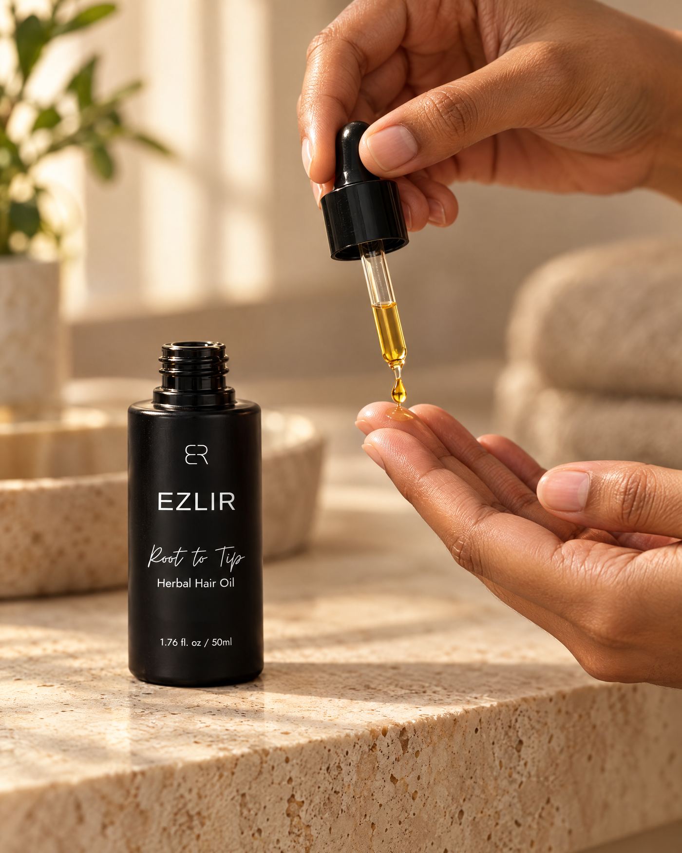 Applying a drop of Root to Tip oil to the fingertips